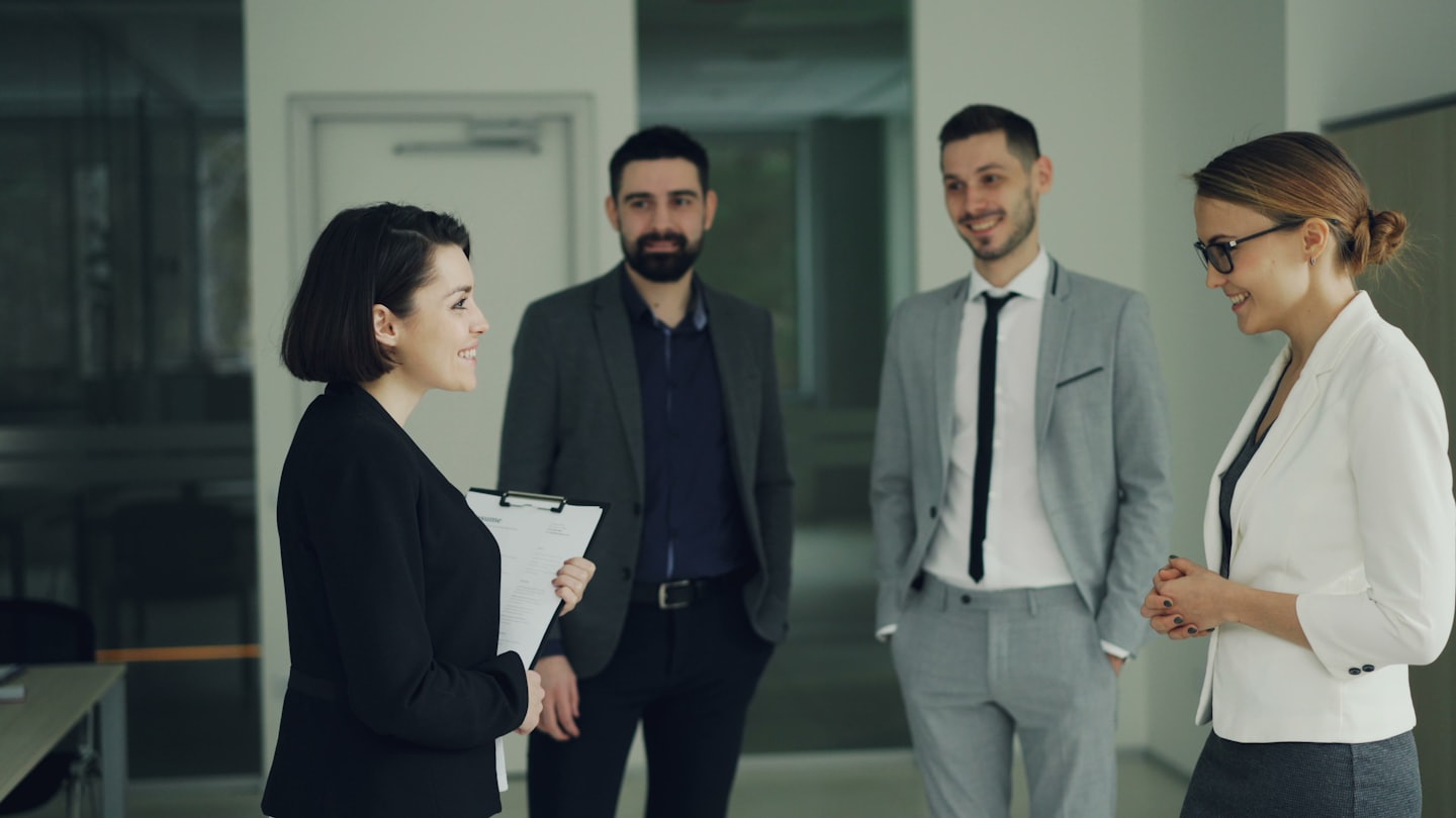 Zakelijke professionals die ideeën bespreken in een moderne kantoorhal.